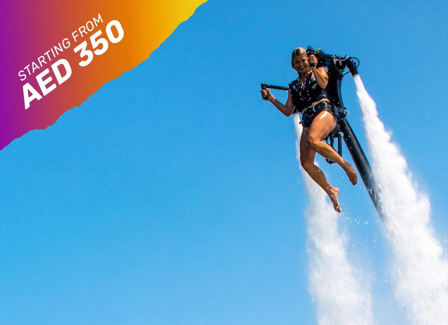 a femlae excitedly enjoying jetpack dubai adventure as she is thrown up in the air