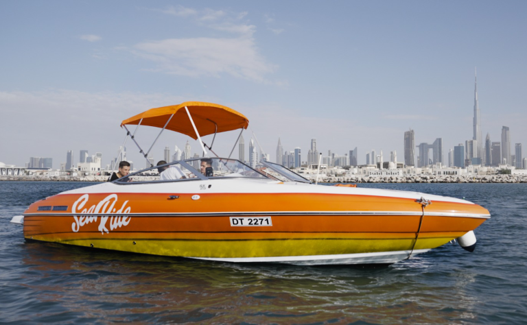orange color boat rental in dubai ocean