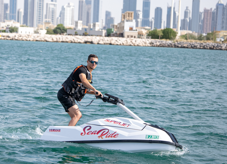 A man posing for photo riding yamaha superjet in Dubai Ocean