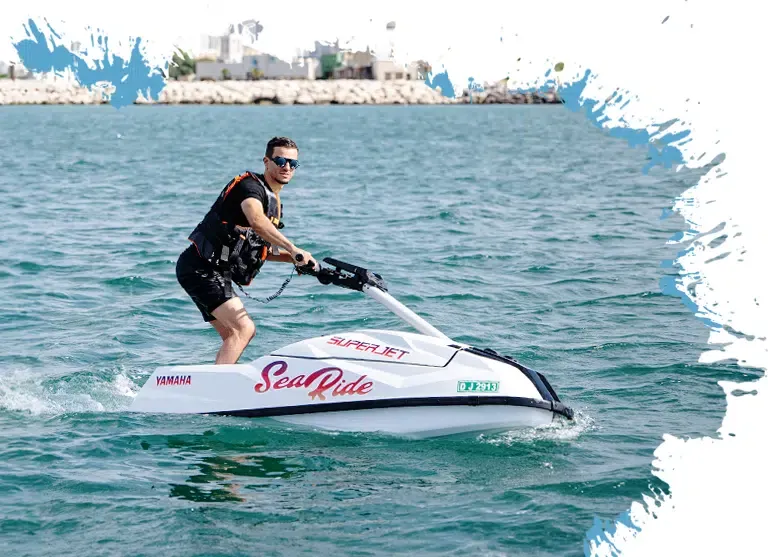 a man posing for photo on a superjet in dubai ocean